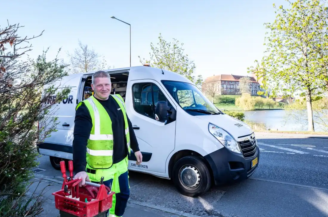 Henton Plumbing technician beside a service van