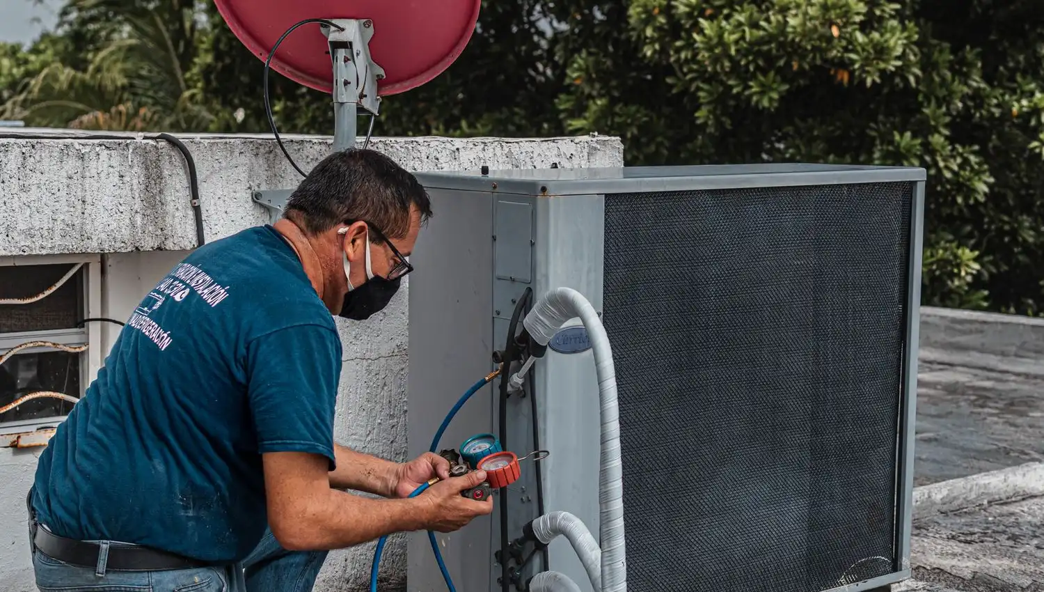 Henton technician servicing an outdoor air conditioning condenser